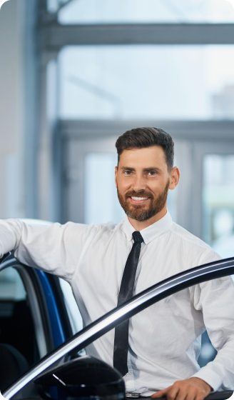 Professional TopRides chauffeur standing by a luxury vehicle